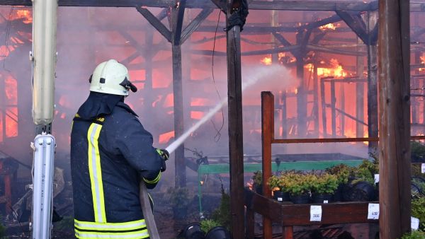 A Ukrainian firefighter intervenes to extinguish a fire at a hardware superstore following a Russian strike, in Kharkiv, on May 25, 2024, amid the Russian invasion of Ukraine. Kharkiv regional governor Oleg Synegubov said at least two people were killed when two Russian guided bombs hit a construction hypermarket. (Photo by SERGEY BOBOK / AFP)