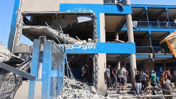 Palestinians survey the damage following the Israeli military bombardment of the UNRWA (United Nations Relief and Works Agency for Palestine Refugees) run Abu Oreiban school, turned shelter, where internally displaced Palestinians are living, in the Nuseirat refugee camp, in the central Gaza Strip on July 14, 2024. (Photo by Eyad BABA / AFP) UNRWA