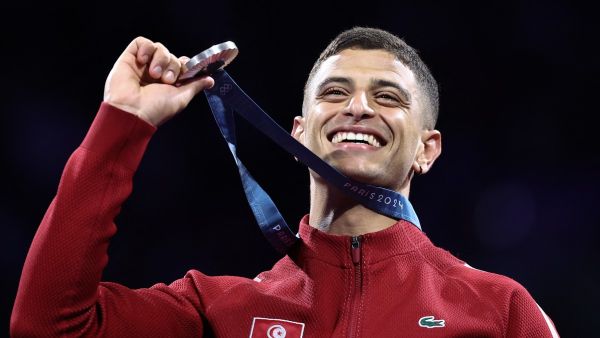 Silver medallist Tunisia's Fares Ferjani celebrates on the podium during the medal ceremony for the men's sabre individual competition during the Paris 2024 Olympic Games at the Grand Palais in Paris, on July 27, 2024. (Photo by Franck FIFE / AFP)