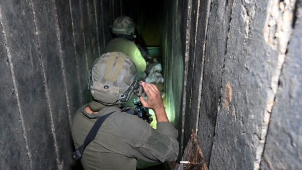 PHOTO TAKEN DURING A CONTROLLED TOUR AND SUBSEQUENTLY EDITED UNDER THE SUPERVISION OF THE ISRAELI MILITARY-- Soldiers walk through what the Israeli army says is a tunnel dug by Hamas militants inside the Al-Shifa hospital complex in Gaza City in the northern Gaza Strip, amid continuing battles between Israel and the Palestinian militant group Hamas, on November 22, 2023. (Photo by Ahikam SERI / AFP)  Israeli soldiers in Gaza Tunnels
