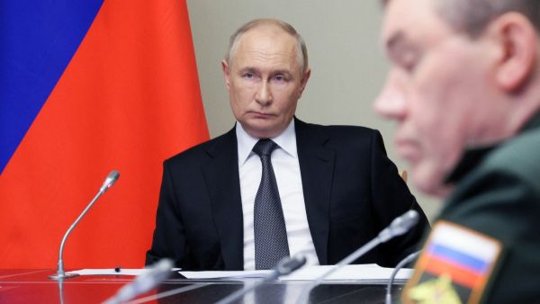 In this pool photograph distributed by Russian state owned agency Sputnik, Russia's President Vladimir Putin (L) chairs a meeting regarding the situation in the Kursk region, in his residence in Novo-Ogaryovo outside Moscow, on August 12, 2024. Photo by Gavriil GRIGOROV / POOL / AFP)