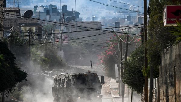 An Israeli military vehicle drives in the occupied West Bank city of Jenin amid ongoing Israeli raids on August 31, 2024. (Photo by RONALDO SCHEMIDT / AFP)