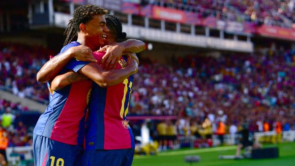 Barcelona's Brazilian forward #11 Raphinha celebrates scoring his team's first goal with Barcelona's Spanish forward #19 Lamine Yamal during the Spanish league football match between FC Barcelona and Real Valladolid FC at the Estadi Olimpic Lluis Companys in Barcelona on August 31, 2024. (Photo by MANU QUINTERO / AFP)