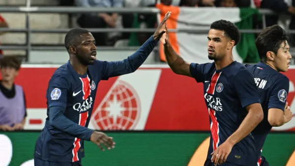 Paris Saint-Germain's French forward #10 Ousmane Dembele (L) celebrates scoring his team's first goal during the French L1 football match between Stade de Reims and Paris Saint-Germain (PSG) at Stade Auguste-Delaune in Reims, northern France on September 21, 2024. (Photo by FRANCOIS NASCIMBENI / AFP)