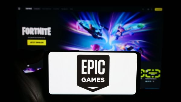 Person holding cellphone with logo of US video game development company Epic Games Inc. in front of business webpage featuring Fortnite. (Shutterstock) Epic Games now suing Google, Samsung over app store