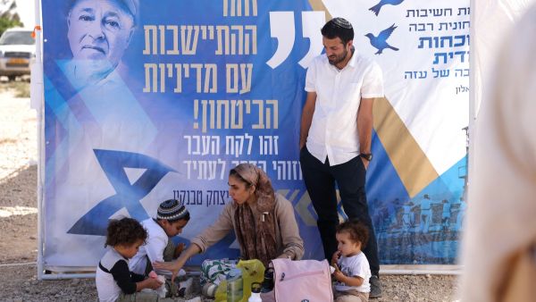 Israeli right-wing activists attend a gathering near the border with Gaza on October 21, 2024, calling to establish a new Jewish settlement in the Gaza Strip.