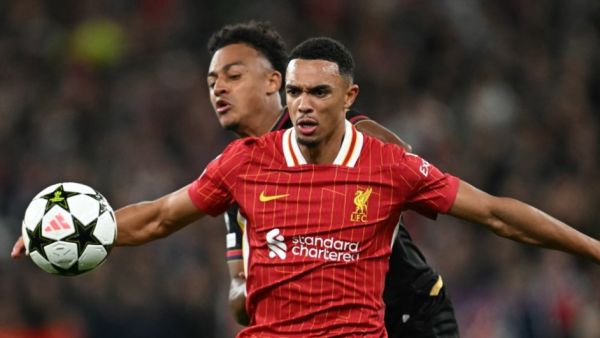 Bologna's Swiss forward #11 Dan Ndoye (R) vies with Liverpool's English defender #66 Trent Alexander-Arnold during the UEFA Champions League league stage football match between Liverpool and Bologna at Anfield in Liverpool, north west England on October 2, 2024. (Photo by Paul ELLIS / AFP)