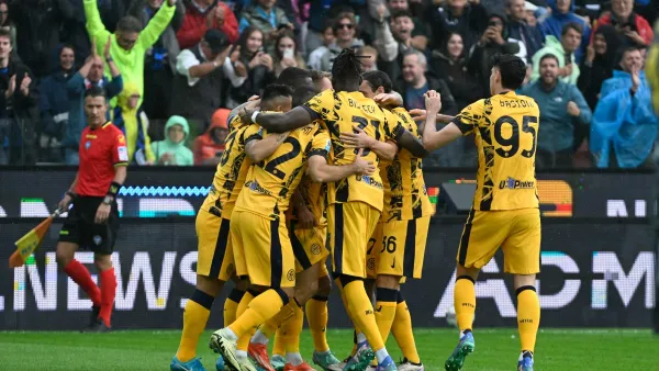 Inter Milan's Italian midfielder #16 Davide Frattesi celebrates with teammates after scoring a goal during the Italian Serie A football match between Udinese and Inter Milan at the Bluenergy Friuli Stadium, in Udine on September 28, 2024. (Photo by ANDREA PATTARO / AFP)