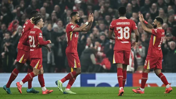 Liverpool's Dutch striker #18 Cody Gakpo (C) celebrates after scoring his team second goal during the UEFA Champions League football match between Liverpool and Bayer Leverkusen at Anfield stadium, in Liverpool, north west England, on November 5, 2024. (Photo by Paul ELLIS / AFP)