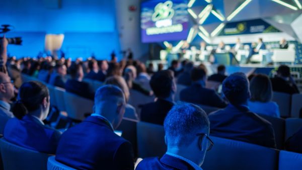 Attentive audience listens as experts discuss global trends at an international business conference. (Shutterstock) Must-attend events for startup founders in 2025