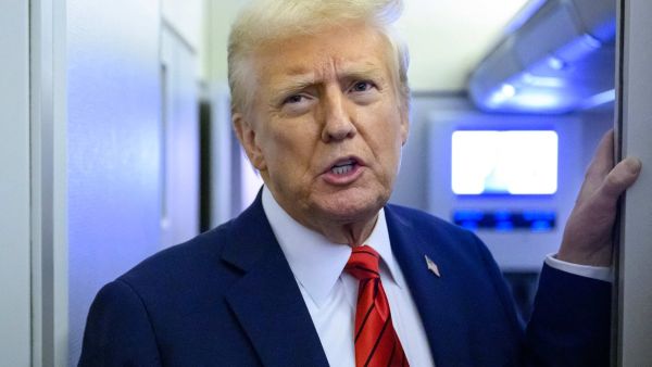 US President Donald Trump speaks to reporters while in flight on Air Force One en route Joint Base Andrews in Maryland on January 27, 2025. (Photo by Mandel NGAN / AFP)