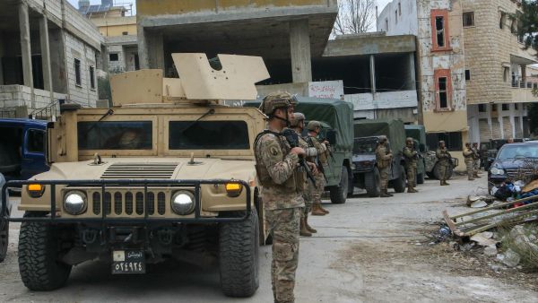 Lebanese soldiers set up a checkpoint to turn back displaced residents attempting to return to their homes at the entrance of the southern Lebanese village of Aitaroun
