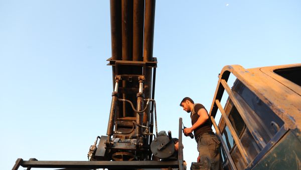 CORRECTION / A Syrian fighter from the Turkish-backed National Liberation Front (NLF) prepares to fire missiles against regime positions on May 13, 2019 in the rebel-held northern part of Syria's Hama province. Clashes on the edge of a jihadist bastion in northwestern Syria have killed at least 42 fighters in 24 hours, a monitor said today, after regime bombardment on the region devastated health services. (Photo by OMAR HAJ KADOUR / AFP) Hamas Strikes Israeli Forces in Rafah as Sirens Sound Across Israel