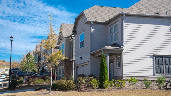 Corner two story houses by large residential street