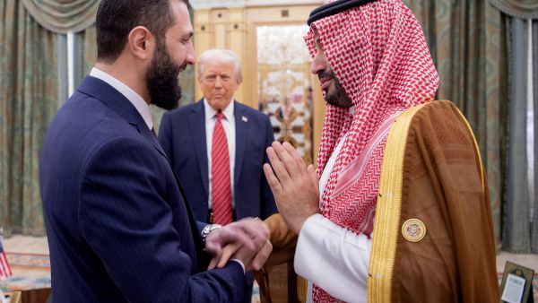A handout picture provided by the Saudi Royal Palace shows Saudi Crown Prince Mohammed bin Salman (R) greeting Syria's interim president Ahmed al-Sharaa as US President Donald Trump looks on, in Riyadh on May 14, 2025. (AFP) Syria without sanctions: details and implications