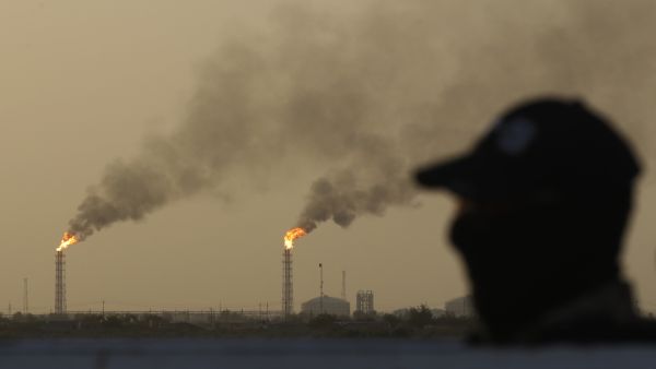 An Iraqi policeman stands guard at the Halfaya oil field belonging to the PetroChina company in the al-Kahla district in the city of Amara south of Baghdad on July 26, 2022. AFP Iraqi presidency condemns drone strikes on northern oil fields, demands accountability