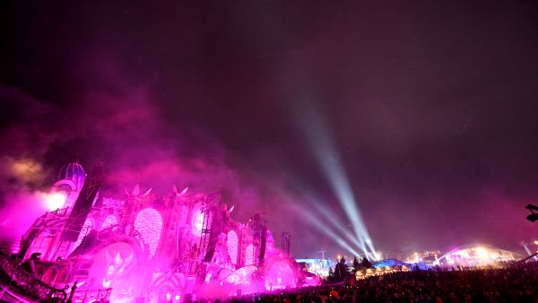 Revelers dance as a DJ performs during the first winter edition of the Tomorrowland electronic music festival, in l'Alpe d'Huez, eastern France, on March 13, 2019. AFP Massive fire destroys Tomorrowland main stage in Belgium, days before festival launch