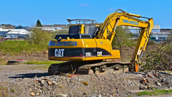 Bridgend. County Borough of Bridgend / Wales UK - 3/24/2019: New building site on the outskirts of Bridgend. A Caterpillar 315CL hydraulic excavator.