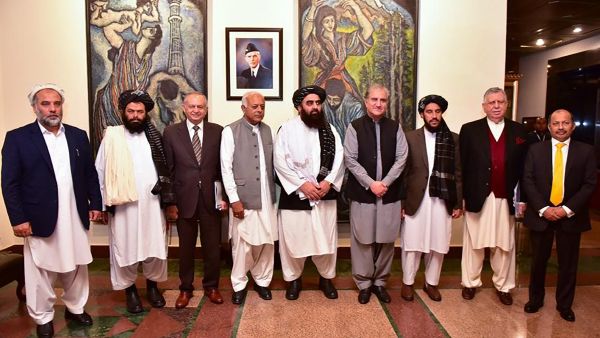 This handout photograph taken and released by Pakistan's Ministry of Foreign Affairs on November 11, 2021, shows Afghanistan's acting Foreign Minister Amir Khan Muttaqi (C), Pakistan's Foreign Minister Shah Mahmood Qureshi (4R), Pakistan Minister for Aviation Ghulam Sarwar Khan (4L), Pakistan's Prime Minister commerce adviser Abdul Razak Dawood (3L) pose for picture along with other delegation members at Pakistan's Foreign Ministry, in Islamabad. AFP Afghanistan, Pakistan extend ceasefire in Istanbul talks