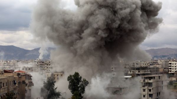 Smoke billows following Syrian government bombardments on Kafr Batna, in the besieged Eastern Ghouta region on the outskirts of the capital Damascus on Feb. 22, 2018. 
(AMER ALMOHIBANY / AFP)