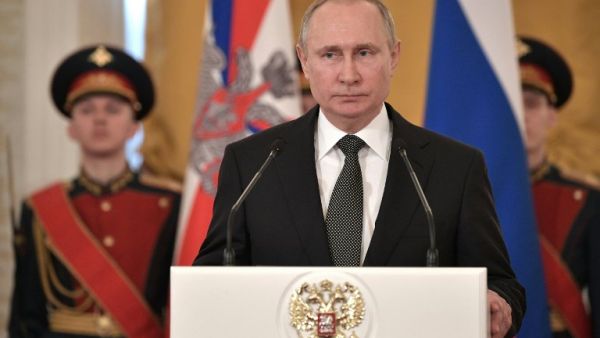 Russian President Vladimir Putin (C) delivers a speech during a ceremony to present national award and to mark the Defender of the Fatherland Day at the Kremlin in Moscow on Feb. 23, 2018. 
(Alexey NIKOLSKY / Sputnik / AFP)