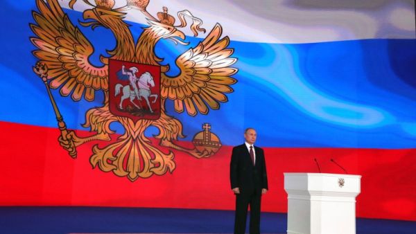 Russian President Vladimir Putin stands on the stage while addressing the Federal Assembly at Moscow's Manezh exhibition centre on Mar. 01, 2018. 
(Mikhail KLIMENTYEV / SPUTNIK / AFP)