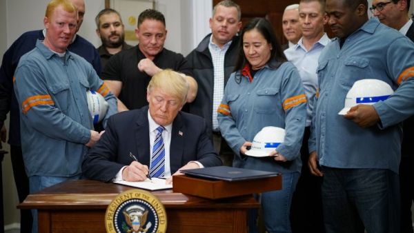 U.S. President Donald Trump signs Section 232 Proclamations on Steel and Aluminum Imports in the Oval Office of the White House on Mar. 8, 2018, in Washington, DC. Trump on Thursday declared the American steel and aluminum industries had been "ravaged by aggressive foreign trade practices" as he signed off on contentious trade tariffs. "It's really an assault on our country," he continued. "I've been talking about this a long time, a lot longer than my political career."
(MANDEL NGAN / AFP)