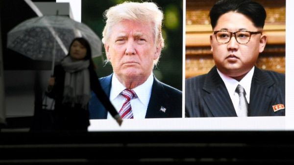 A pedestrian walks in front of a huge screen flashing a news report relating to U.S. President Donald Trump and North Korean leader Kim Jong agreeing to meet for talks in Tokyo on Mar. 9, 2018. Japan's prime minister on March 9 welcomed the surprise announcement of a summit between U.S. President Donald Trump and North Korea's Kim Jong Un by the end of May.
(Toshifumi KITAMURA / AFP)