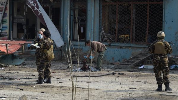 An Afghan investigator (C) inspect the remains of a body at the site where a suicide attacker blew himself up in a Shiite area of Kabul on Mar. 9, 2018. A suicide bomber on foot blew himself up in Kabul's Shiite area on Mar. 9, killing at least seven people, officials said, as militants dial up pressure on the war-weary Afghan capital.
(SHAH MARAI / AFP)
