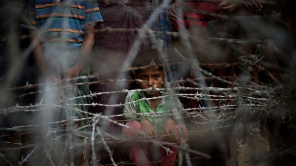 Rohingya refugees gather in the "no man's land" behind the Myanmar border lined with barb wire fences just inside Bangladesh (AFP/File Photo)