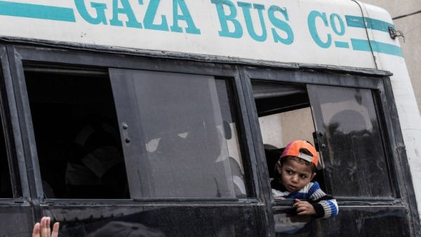 A boy looks out from a window as he rides on a bus waiting in Khan Yunis to cross into Egypt from the Rafah border crossing in the southern Gaza Strip on April 28, 2018, after it was opened for three days to allow humanitarian cases to pass. 
(SAID KHATIB / AFP)