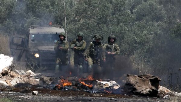 Israeli soldiers take position as Palestinian protesters clash with Israeli forces during a weekly demonstration against the expropriation of Palestinian land by Israel in the village of Kfar Qaddum, near Nablus in the occupied West Bank, on May 11, 2018. 
(JAAFAR ASHTIYEH / AFP)