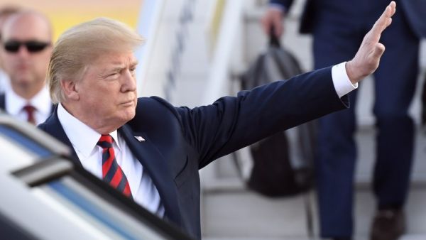 US President Donald Trump waves upon arrival at Helsinki-Vantaa Airport in Helsinki, on July 15, 2018 on the eve of a summit in Helsinki between the US President and his Russian counterpart. 
Heikki Saukkomaa / Lehtikuva / AFP 