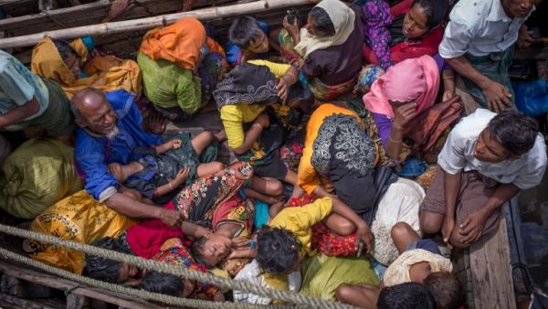 Rohingya refugees arriving by boat at Shah Parir Dwip on the Bangladesh side of the Naf River (AFP)
