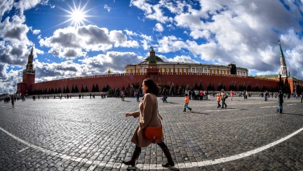 A woman walks on Red Square in front of the Kremlin in downtown Moscow (AFP)