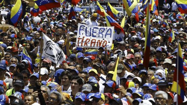 Supporters listen to Venezuelan opposition leader and self-proclaimed interim president Juan Guaido during a rally in Valencia, Carabobo State, Venezuela, on March 16, 2019. (AFP)