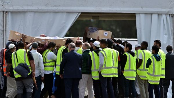 Mourners carry the coffins of Khalid Mustafa and his son Hamza Mustafa, slain by an Australian white supremacist gunman who shot down 50 Muslims at two mosques, during a funeral at the Memorial Park cemetery in Christchurch on March 20, 2019. (AFP/ File)