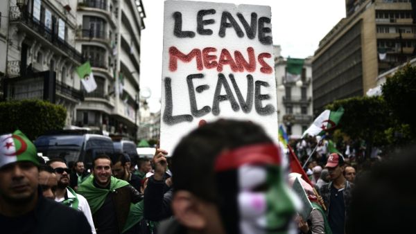 Algerians hold a placard as they take part in an anti-government demonstration, on April 5, 2019 in the capital Algiers. (RYAD KRAMDI / AFP)