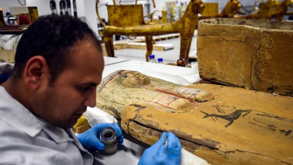 A restorer works on a sarcophagus part of the Tutankhamun collection at the restoration lab of the newly-built Grand Egyptian Museum (GEM) in Giza on the southwestern outskirts of the capital Cairo on April 7, 2019. 
(Mohamed el-Shahed / AFP)