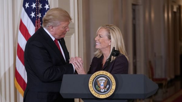 US President Donald Trump clasps hands with Kirstjen Nielsen after nominating her to be the next Homeland Security Secretary in the East Room of the White House in Washington, DC. US President Donald Trump  (AFP)
