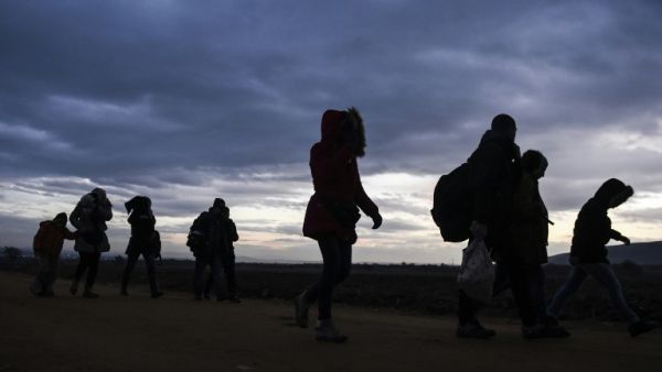 Migrants and refugees walk after crossing the Macedonian border into Serbia on January 10, 2016. More than a million refugees and migrants arrived in Europe in 2015. (AFP/Armend Nimani)