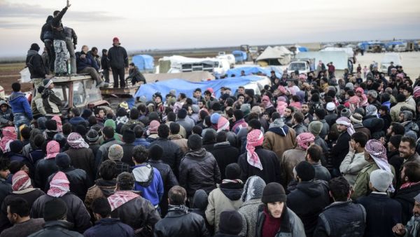Syrians fleeing the northern embattled city of Aleppo wait on February 5, 2016 in Bab-Al Salama, next to the city of Azaz, northern Syria. (AFP/Bulent Kilic)