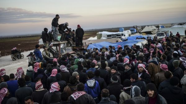 Syrians fleeing the northern embattled city of Aleppo wait on February 5, 2016 in Bab-Al Salama, next to the city of Azaz, northern Syria. (AFP/Bulent Kilic)