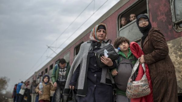 Migrants and refugees board a train after crossing the Greek-Macedonian border near Gevgelija on February 24, 2016. (AFP/Robert Atanasovski)