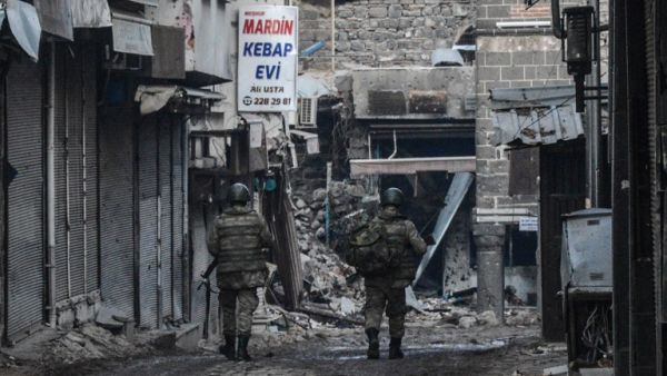 Turkish soldiers walk on February 26, 2016 during a curfew in Diyarbakir's historical Sur district, eastern Turkey. (AFP/Ilyas Akengin)