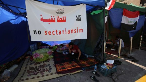 A supporter of Iraqi Shia cleric Moqtada al-Sadr sits inside a tent on the fourth day of a sit-in calling for governmental reform and elimination of corruption on March 22, 2016, outside the main gates of Baghdad's Green Zone. (AFP/Ahmad al-Rubaye)
