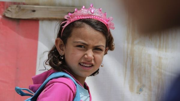 A Syrian refugee girl heads to school at an unofficial refugee camp in Lebanon (AFP/File Photo)	