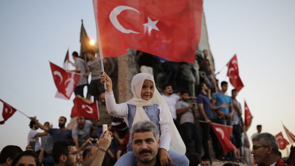 A child waves Turkish flags in Taksim square in Istanbul on July 16, 2016 during a demonstration in support to Turkish president. (AFP photo)