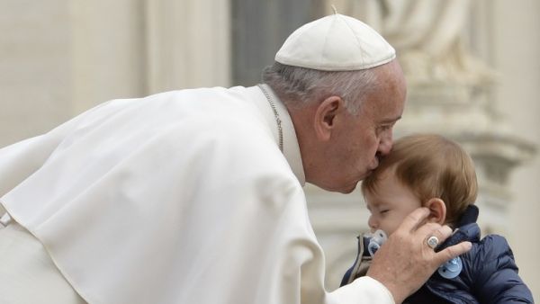 Pope Francis kisses a baby as he arrives for his weekly general audience at St Peter's square on September 30, 2015 at the Vatican. (AFP/Andreas Solaro)
