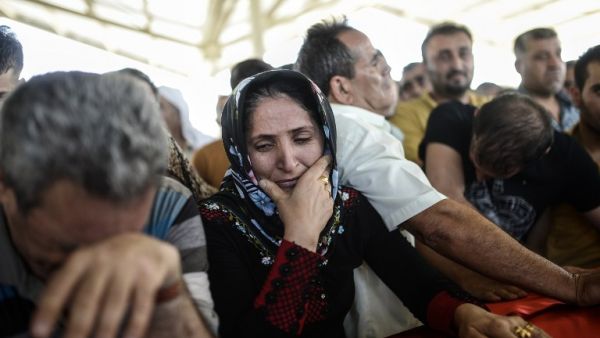 Family members of the victims of the suicide bombing attack in the Turkish city of Suruc gathered for a funeral service on Tuesday, July 21, 2015. (AFP/Bulent Kilic)
